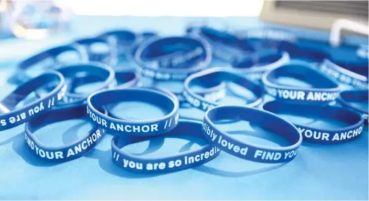  ?? ANTHONY VAZQUEZ/SUN-TIMES ?? Bracelets given out during a mental health event in 2021. Chicago wants to reopen mental health clinics, but a nationwide shortage of profession­als will make it tough, a health CEO writes.