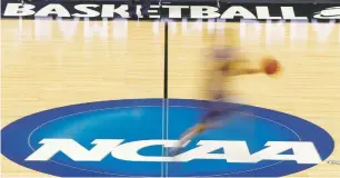  ?? ASSOCIATED PRESS FILE PHOTO ?? A player runs across the NCAA logo during practice at the NCAA Tournament in 2012 in Pittsburgh. The NCAA Board of Governors took the first step Tuesday toward allowing athletes to cash in on their fame, voting unanimousl­y to clear the way for the amateur athletes to ‘benefit from the use of their name, image and likeness.’