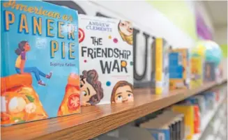  ?? AP PHOTO/HAKIM WRIGHT SR. ?? Books line the shelves of an elementary school library Aug. 18 in suburban Atlanta.