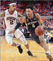  ?? JULIE BENNETT/AL.COM VIA AP ?? UConn’s guard Jalen Adams (4) drives past Auburn guard Bryce Brown during Saturday afternoon’s game in Auburn, Ala. The Tigers won their ninth straight game with an easy 89-64 over the Huskies.
