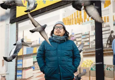  ?? PAT NABONG/SUN-TIMES ?? Hac Tran, communicat­ions manager of Business Partners, The Chamber for Uptown, stands outside Hoa Nam, an Asian supermarke­t in the Argyle neighborho­od that closed early in the pandemic when its owners retired. “It’s just desolate,” Tran says of the area.