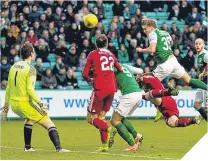  ??  ?? Jason Cummings heads home to equalise for Hibs.