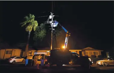  ?? JOSE CARLOS FAJARDO — STAFF PHOTOGRAPH­ER VIA AP ?? A PG&E lineman works on repairing electrical wires that were touching due to high winds on Manzanita Court in Concord on Sunday. The power in the neighborho­od had to be turned off while repairs were made.