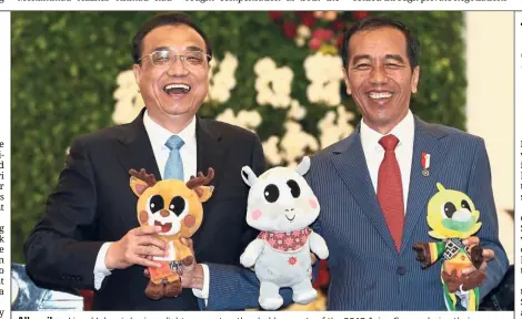  ??  ?? All smiles: Li and Jokowi sharing a light moment as they hold mascots of the 2018 Asian Games during their meeting at the presidenti­al palace in Bogor. — AFP
