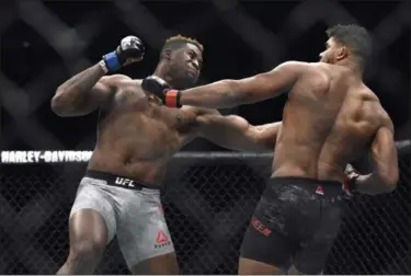  ?? JOSE JUAREZ — ASSOCIATED PRESS ?? Francis Ngannou, left, hits Alistair Overeem in the first round during a UFC 218 heavyweigh­t bout Dec. 2.