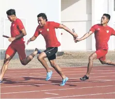  ??  ?? Indonesian sprinter Lalu Zohri (centre) takes part in training session at the Senayan sport complex in Jakarta. — AFP photo