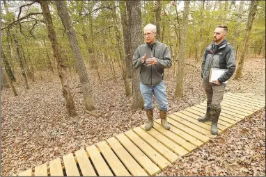  ?? (NWA Democrat-Gazette/Andy Shupe) ?? Ted Jack (left), park planning superinten­dent for the city of Fayettevil­le, and Zach Foster, park planner, show a boardwalk Friday that the city constructe­d in an area that remains muddy after a rain along the Saddle Up trail at Kessler Mountain Regional Park in Fayettevil­le. The city plans to make improvemen­ts to the trail at the southern end of the regional park that is popular for users of a wide range of ages and abilities but floods frequently. Visit nwaonline.com/photo for today’s photo gallery.