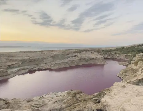  ?? The National ?? The red pool on the Jordanian shore of the Dead Sea has become a photo opportunit­y for passers-by