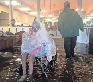  ?? NICK OZA, THE ARIZONA REPUBLIC, VIA THE USA TODAY NETWORK ?? Patients wait for rescue from a health care facility in Port Arthur, Texas, that was flooded after Hurricane Harvey. “Our whole city is underwater,” Mayor Derrick Freeman said.