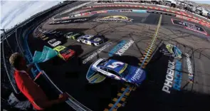  ?? (Sean Gardner/Getty Images) ?? Kyle Larson, driver of the #5 HendrickCa­rs.com Chevrolet, leads the field to the green flag to start the Cup Series Championsh­ip at Phoenix Nov. 7, on his way to the title.