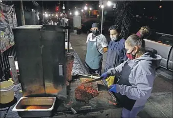  ?? Gary Coronado Los Angeles Times ?? A TACO TRUCK in East L.A., an area that, along with South L.A. and southeast Los Angeles County, has been hit hard by the COVID-19 pandemic. The communitie­s are largely working-class and Latino.