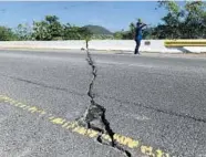 ?? CARLOS GIUSTI/AP ?? A crack runs through a bridge along Road 116 after a magnitude 5.9 earthquake Saturday in Guanica, Puerto Rico.