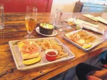  ??  ?? A split shrimp po’ boy and fries, and a bowl of Texas Chili at Rowley Farmhouse Ales.