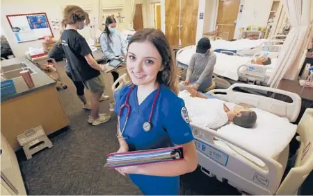  ?? GARY KAZANJIAN/AP ?? Emma Champlin, a first-year nursing student in California, said the pandemic has given her a chance to learn and apply critical-care skills.