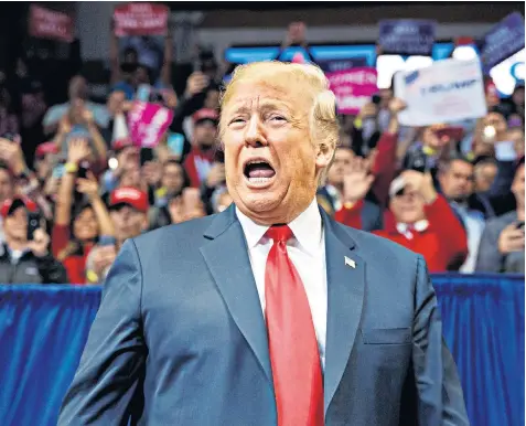  ??  ?? Donald Trump calls out to the cheering crowd as he arrives to speak at a rally at Allen County War Memorial Coliseum in Fort Wayne, Indiana, on Monday