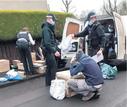  ??  ?? Operation: Police search the men’s van for suspected stolen property