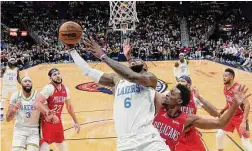  ?? Gerald Herbert/Associated Press ?? Los Angeles Lakers forward LeBron James (6) goes to the basket in the second half of a NBA game against the New Orleans Pelicans Saturday in New Orleans.