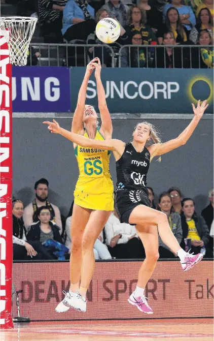  ?? PHOTO: GETTY IMAGES ?? Reach for the sky . . . Australian Diamonds goal shoot Caitlin Bassett and Silver Ferns goal keep Jane Watson compete for the ball during the Quad Series match at Hisense Arena in Melbourne yesterday.