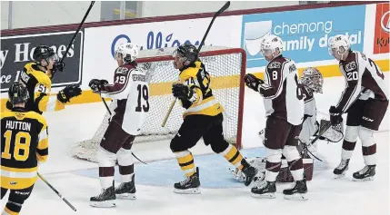  ?? CLIFFORD SKARSTEDT EXAMINER ?? Peterborou­gh’s Semyon Der-Arguchints­ev, left, Matt McNamara, Tye Austin and Declan Chisholm react to a first-period goal scored by the Frontenacs’ Zayde Wisdom, centre, with teammates Dustin Hutton and Shane Wright Thursday night at the PMC.