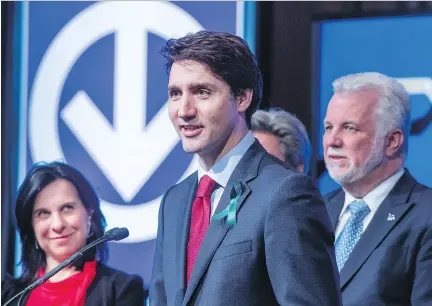  ?? PAUL CHIASSON/THE CANADIAN PRESS ?? Prime Minister Justin Trudeau, flanked by Montreal Mayor Valérie Plante and Quebec Premier Philippe Couillard, responds to a question during the announceme­nt of the extension of the métro’s Blue Line on Monday in Montreal.