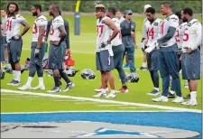  ?? TONY GUTIERREZ/AP PHOTO ?? Houston Texans players stand on the sideline waiting to run sprints at the start of a morning practice Monday at the Dallas Cowboys training facility in Frisco, Texas. The Texans are using the Cowboys facility because of the floods currently pounding...