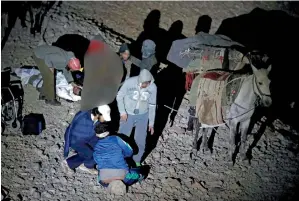  ?? AFP ?? Wounded Syrian men sitting next to their mules after arriving at a meeting point with Israeli soldiers on Mount Hermon in the Israeli-occupied Golan Heights. —