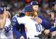  ?? WALLY SKALIJ/TRIBUNE NEWS SERVICE ?? The Los Angeles Dodgers' Justin Turner (10) and Clayton Kershaw embrace after a 3-1 win against the Houston Astros in Game 1 of the World Series in Los Angeles on Tuesday.