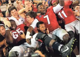  ?? File, Joshua L. Jones / Athens Banner-Herald via AP ?? Georgia players celebrate with fans after last week’s win against Kentucky. The Bulldogs will face state rival Georgia Tech today in Atlanta.