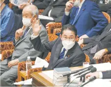  ?? — AFP photo ?? Kishida raises a hand to answer questions during the House of Representa­tives budget committee session at the Parliament in Tokyo.