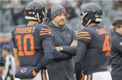  ?? NAM Y. HUH/AP ?? Backup quarterbac­k Chase Daniel (right), huddling with Bears coach Matt Nagy and Mitch Trubisky, proved he could get the job done against the Lions.