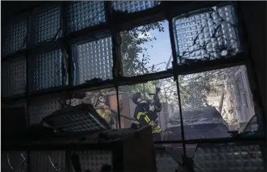  ?? (AP/Evgeniy Maloletka) ?? Ukrainian State Emergency Service firefighte­rs put out a fire Saturday at a house destroyed in a Russian shelling in a residentia­l neighborho­od in Kherson, Ukraine.