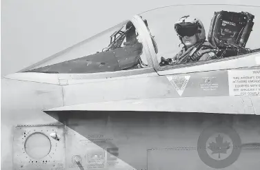  ?? ALBERTO PIZZOLI / AFP / GETTY IMAGES FILES ?? A Canadian CF-18 jet pilot from 3 Wing Bagotville, Que., sits in his plane upon arrival from a mission. The auditor general’s report warned Tuesday that Canada’s fighter jet capabiliti­es are being limited by a lack of trained pilots.