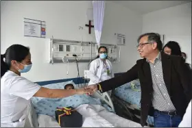  ?? (AP/Colombia’s Press Office) ?? Colombia’s President Gustavo Petro greets a nurse tending to one of the four Indigenous children who survived an Amazon plane crash that killed three adults and then braved the jungle for 40 days before being found alive, at a military hospital Saturday in Bogota, Colombia.