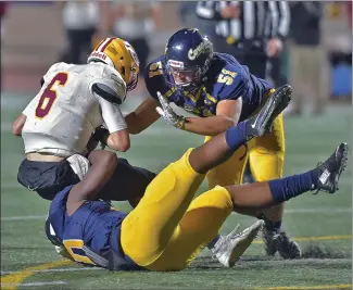  ?? Dan Watson/The Signal ?? COC’s Bradley Brown (10) and Benjamin Seymour (51) bring down Saddleback College quarterbac­k Chance Nolan (6) in the second quarter at COC on Saturday. Canyons defeated Saddleback 53-51.