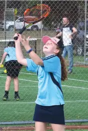  ??  ?? Issabelle Sowerby serves during Baw Baw junior tennis.