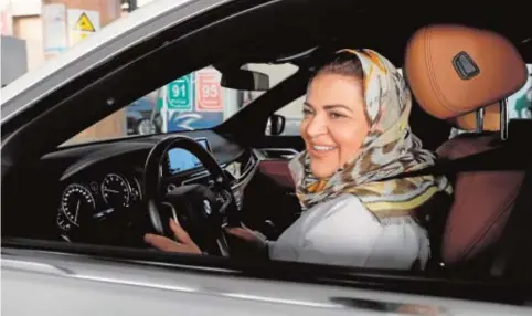  ??  ?? La doctora Samira al-Ghamdi, ayer, conduciend­o su coche de camino al trabajo en Jeddah