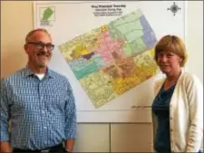  ?? BRIAN MCCULLOUGH DIGITAL FIRST MEDIA ?? John Weller and Mimi Gleason stand in front of a zoning map in the West Whiteland Township Building. Township officials are seeing renewed interest in developing in the township.