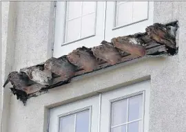  ?? Jeff Chiu Associated Press ?? BROKEN ENDS of joists protrude from the Library Gardens after a balcony collapsed. Experts wondered how the wood could rot in only eight years.