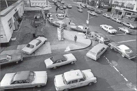  ?? MARTY LEDERHANDL­ER/AP PHOTO ?? Cars line up in two directions at a gas station in New York City in 1973. An unhappy confluence of events has economists reaching back to the days of disco and the bleak high-inflation, high-unemployme­nt economy of nearly a half century ago. No one thinks stagflatio­n is in sight. But as a longerterm threat, it can no longer be dismissed.