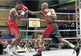  ?? / NICK LOURENS ?? Top-rated junior bantamweig­ht contender Sikho ‘Sequence’ Nqothole, right, lands a punch on his opponent. He faces Immanuel Joseph on Sunday.