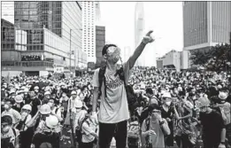  ?? ANTHONY KWAN/GETTY ?? A protester in Hong Kong gestures at a rally Wednesday against an extraditio­n law.