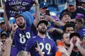  ?? The Associated Press ?? Baltimore Ravens fans cheer during the second half of a game against the Denver Broncos on Sunday in Denver.