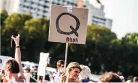  ??  ?? One of numerous QAnon signs at the Querdenken­089 demo in Munich on 12 September 2020. Photograph: Sachelle Babbar/ZUMA Wire/REX/Shuttersto­ck