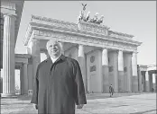  ?? Associated Press ?? Former German chancellor Helmut Kohl passes the Brandenbur­g Gate during a private walk in Berlin in 2003. He died Friday.