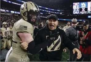  ?? (AP/Winslow Townson) ?? Army Coach Jeff Monken (center) celebrates with Max DiDomenico after a 17-11 victory over Navy on Saturday in Foxborough, Mass.