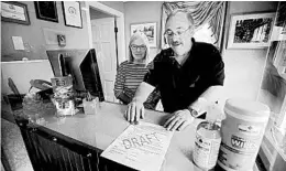  ?? ROBERT F. BUKATY/AP ?? Cod Cove Inn owners Ted and Jill Hugger show a form June 10 in Edgecomb, Maine, that inn owners may be required to have out-of-state guests sign before checking in.