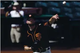  ?? ASHLEY LANDIS — THE ASSOCIATED PRESS ?? Giants starting pitcher Alex Wood (57) throws to first during the first inning of Thursday’s spring game against the White Sox in Scottsdale, Arizona.