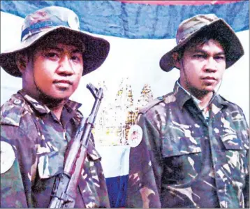  ?? SUPPLIED ?? KNLF founder Sam Serey (right) is seen in a photograph included in a government dossier of evidence purporting that Serey planned to bomb Phnom Penh and Siem Reap.