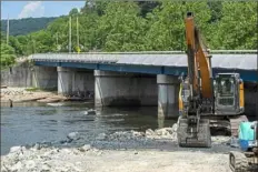  ?? Christian Snyder/Post-Gazette ?? Plum Contractin­g Inc. works July 7 to upgrade the Route 381 bridge over the Youghioghe­ny River in Ohiopyle. The project included a numver of other changes to eliminate close calls between motorists and visitors to Ohiopyel State Park..