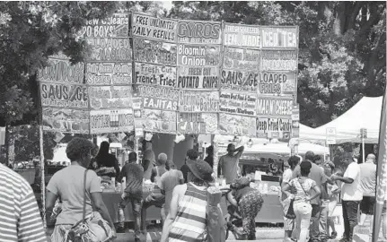  ?? ALGERINA PERNA/BALTIMORE SUN ?? Despite the heat and unpredicta­ble weather, residents journeyed Saturday to the annual AFRAM Festival in Druid Hill Park. The free festival continues today from noon to 6 p.m. For details, go to baltimore.org/events/afram-2018.